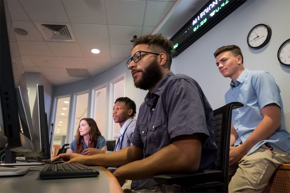 A Fox professor steps in to show a student how something is done.